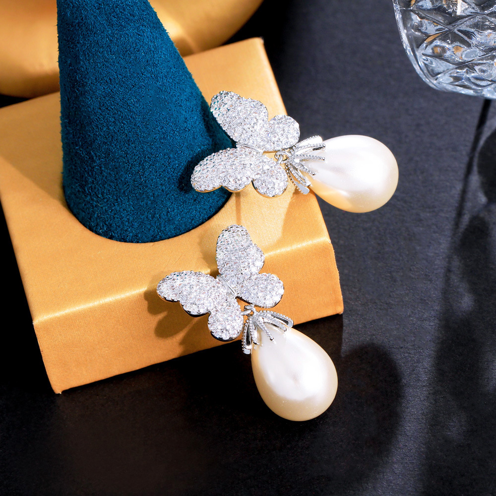 French-style bow-shaped pearl earrings with a sweet and elegant look featuring three-dimensional micro-set zirconia stones S925 silver stud earrings an extremely enchanting accessory