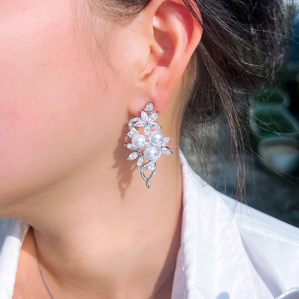 Korean high-class lady's pearl fringed drop earrings featuring mother-of-pearl elegant and sophisticated long-stemmed diamond-set earrings