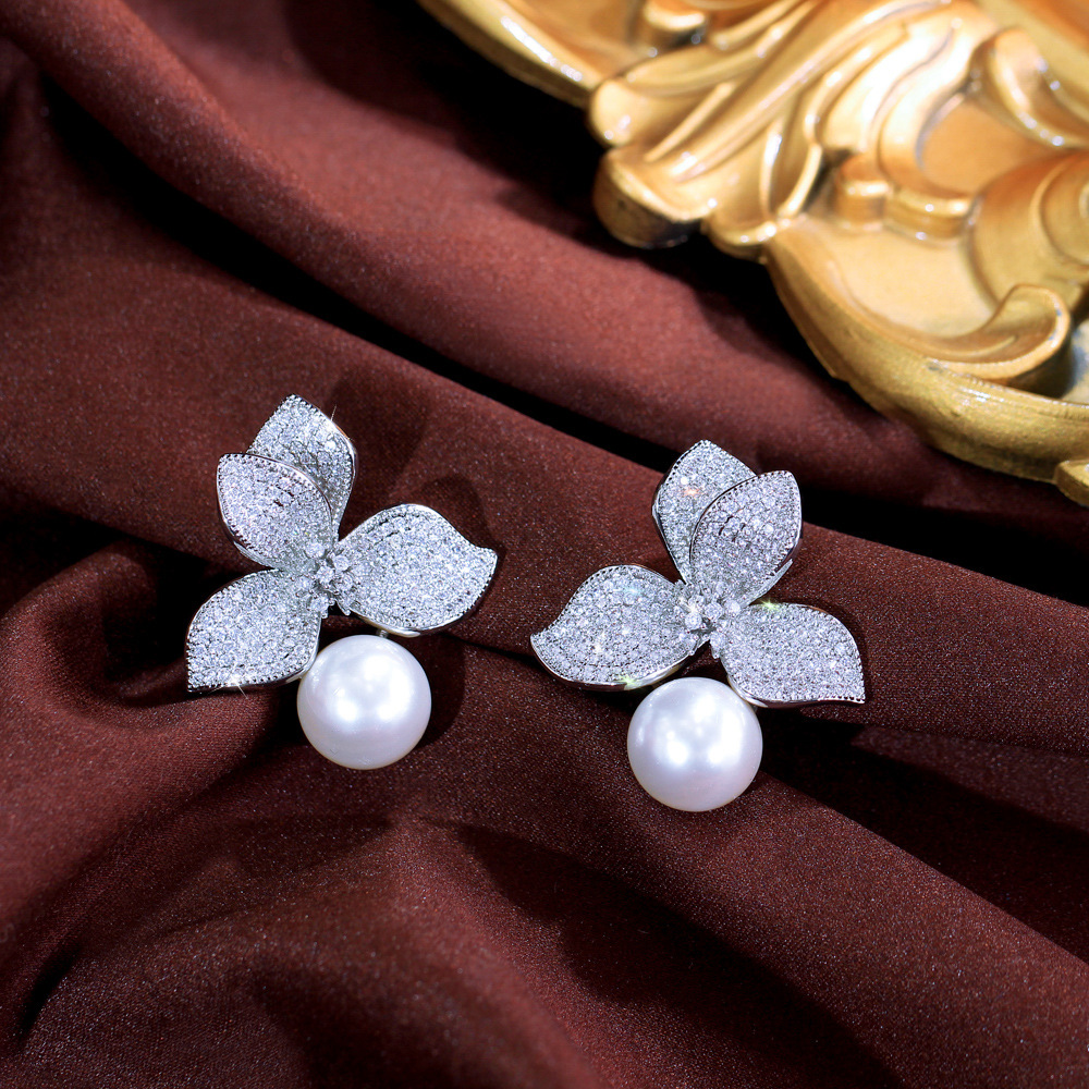 S925 silver needle luxury petal pearl earrings, small-scale design with unique style, exudes a sense of sophistication. Flower-shaped zirconia earrings as an accessory.