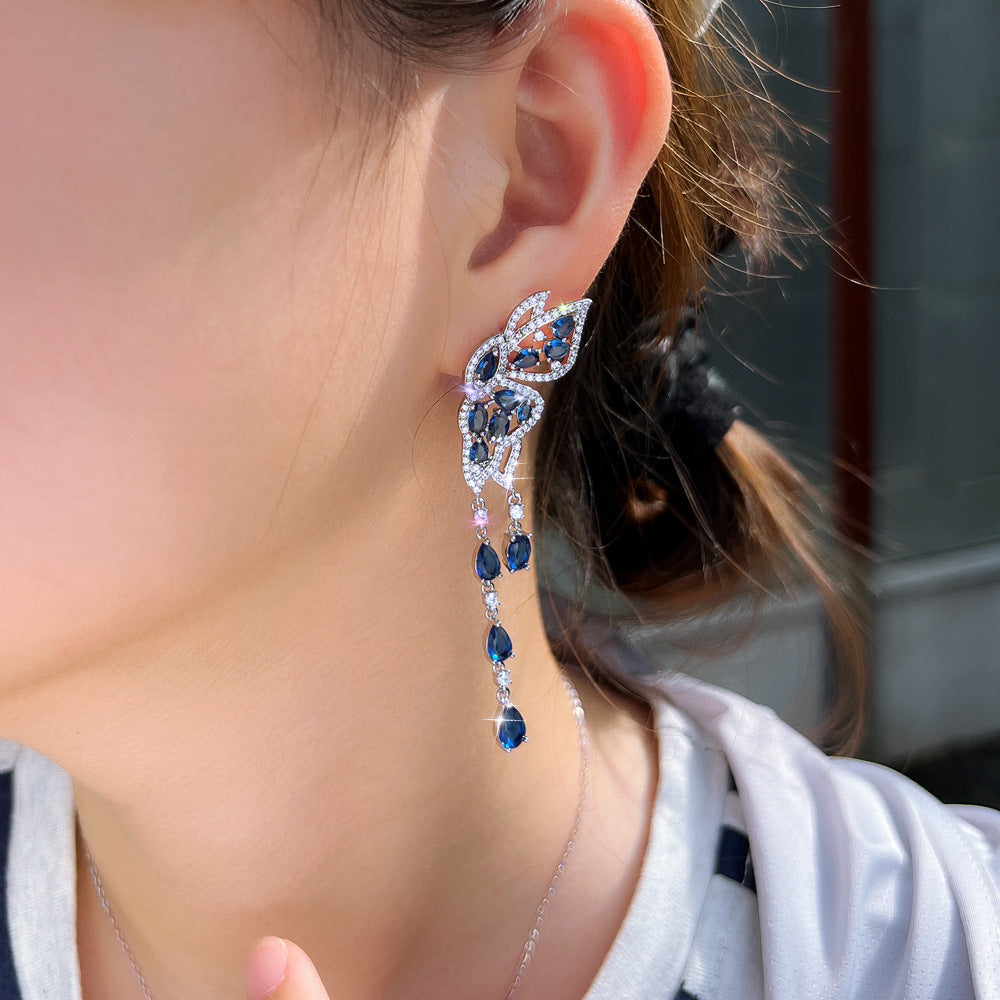 S925 silver needle long-style butterfly fringed earrings enhance facial shape and temperament They resemble a pair of flying swallows Drop earrings as an accessory for the ears